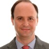 Smiling person in a formal suit portrait